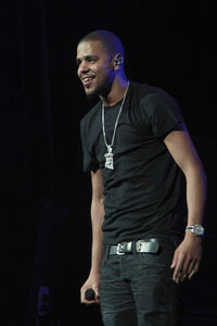 Full length of young man standing against black background