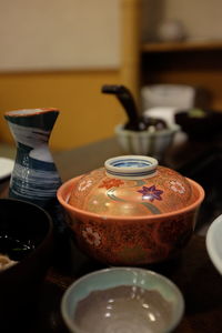 Ceramics bowls and container on restaurant table