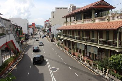 Vehicles on road along buildings