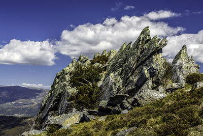 Rock formation on field against sky