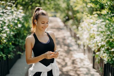 Young woman using mobile phone outdoors