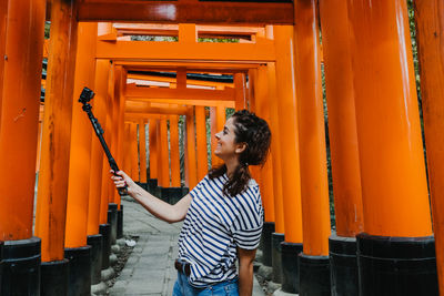 Woman looking away while standing on building