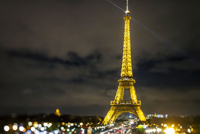 Low angle view of illuminated ferris wheel at night