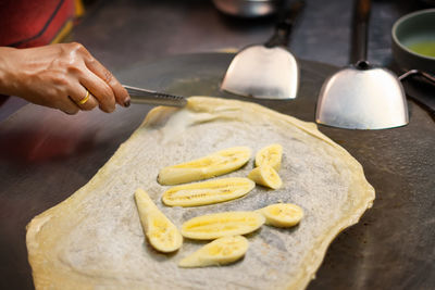 Midsection of person preparing food on table