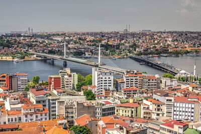 High angle view of river amidst buildings in city against sky