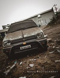 Abandoned car against sky