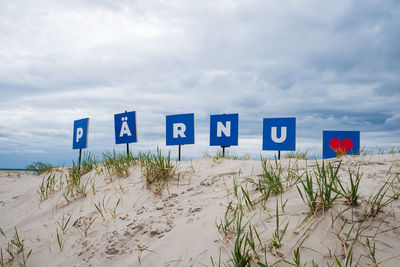 Pärnu sign on sand dunes at pärnu beach.