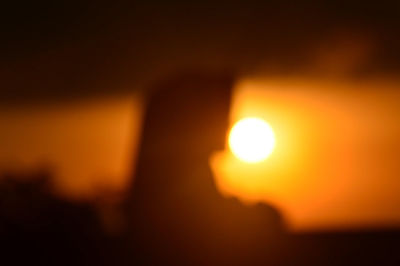 Defocused image of sun in sky during sunset