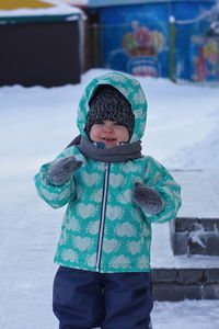Cute boy standing in snow