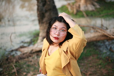 Portrait of beautiful young woman in forest