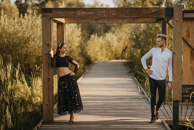 Young couple standing on wood