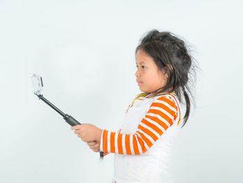 Side view of girl looking away over white background