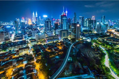 High angle view of city lit up at night