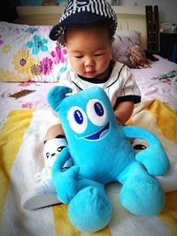 Close-up of cute boy playing with toy at home