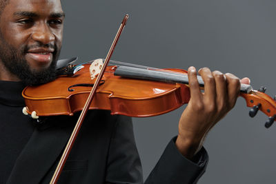 Midsection of man playing violin