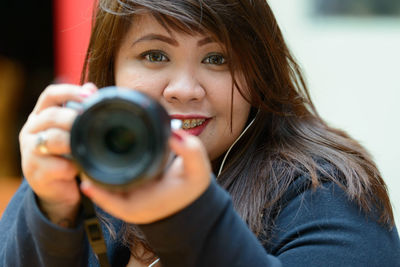 Portrait of woman photographing