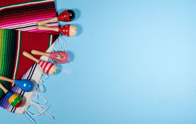 High angle view of multi colored pencils on table against blue background