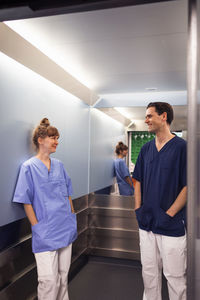 Medical staff talking in hospital elevator