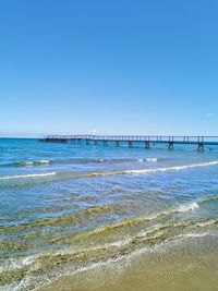 Scenic view of sea against clear blue sky