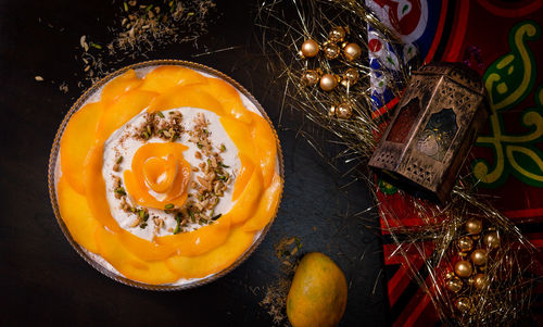 Directly above shot of fruit in bowl by decorations on table