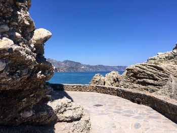 Scenic view of sea against clear blue sky