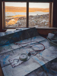 Close up of a compass and map inside a cabin in lapland.