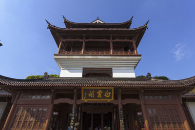 Low angle view of temple against blue sky