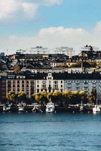 Buildings by sea against sky in city