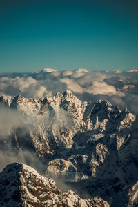 Aerial view of snowcapped mountains against sky