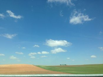 Scenic view of field against blue sky