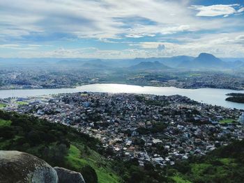Scenic view of river and mountains against sky