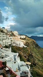 High angle view of townscape by sea against sky