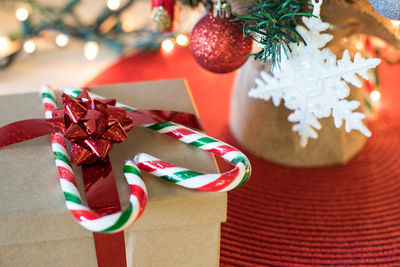 Christmas tree decorations on table. christmas tree with gift box and candy cones in heart shape.