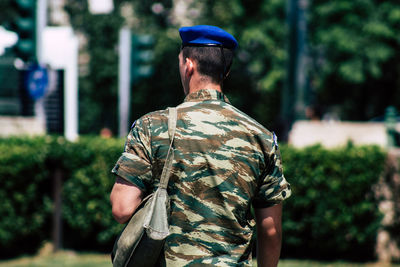 Rear view of man standing against trees