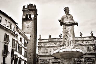 Low angle view of statue against historic building