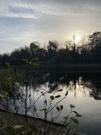 Scenic view of lake against sky at sunset