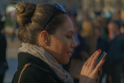 Close-up of woman using mobile phone outdoors