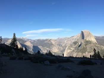 Panoramic view of snowcapped mountains against blue sky