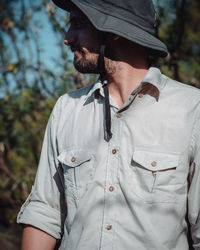 Midsection of young man looking at camera