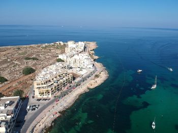 High angle view of sea and cityscape against sky