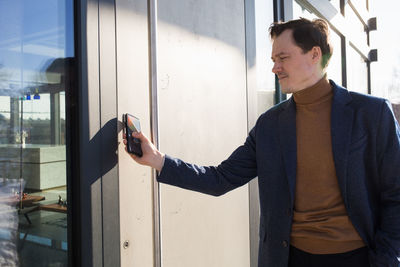 Businessman using mobile phone outdoors