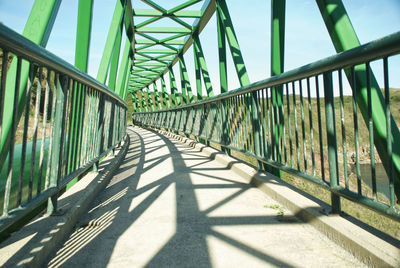 Shadow of railing on footbridge