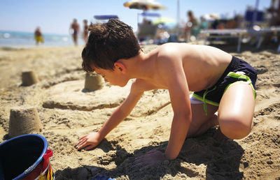 Shirtless boy on beach