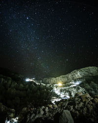 Scenic view of illuminated rocks against sky at night