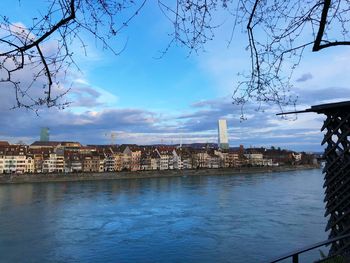 View of river and buildings against sky