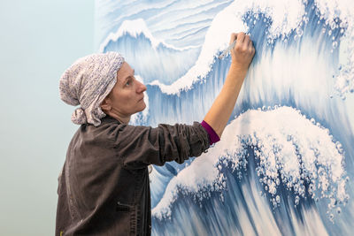 Side view of woman standing in snow