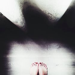 Low section of woman standing on tiled floor