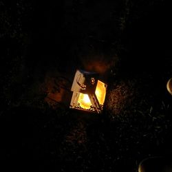 Illuminated lantern at night