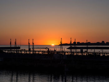 Silhouette pier on sea against sky during sunset