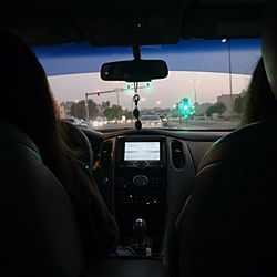 Cropped image of man driving car